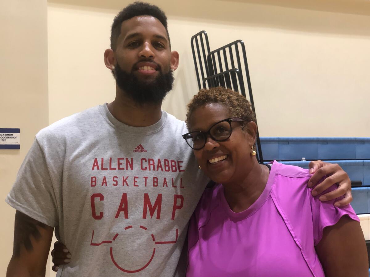 Allen Crabbe of the Atlanta Hawks with his mother, Cheryl, while running a camp at his alma mater, Los Angeles Price.