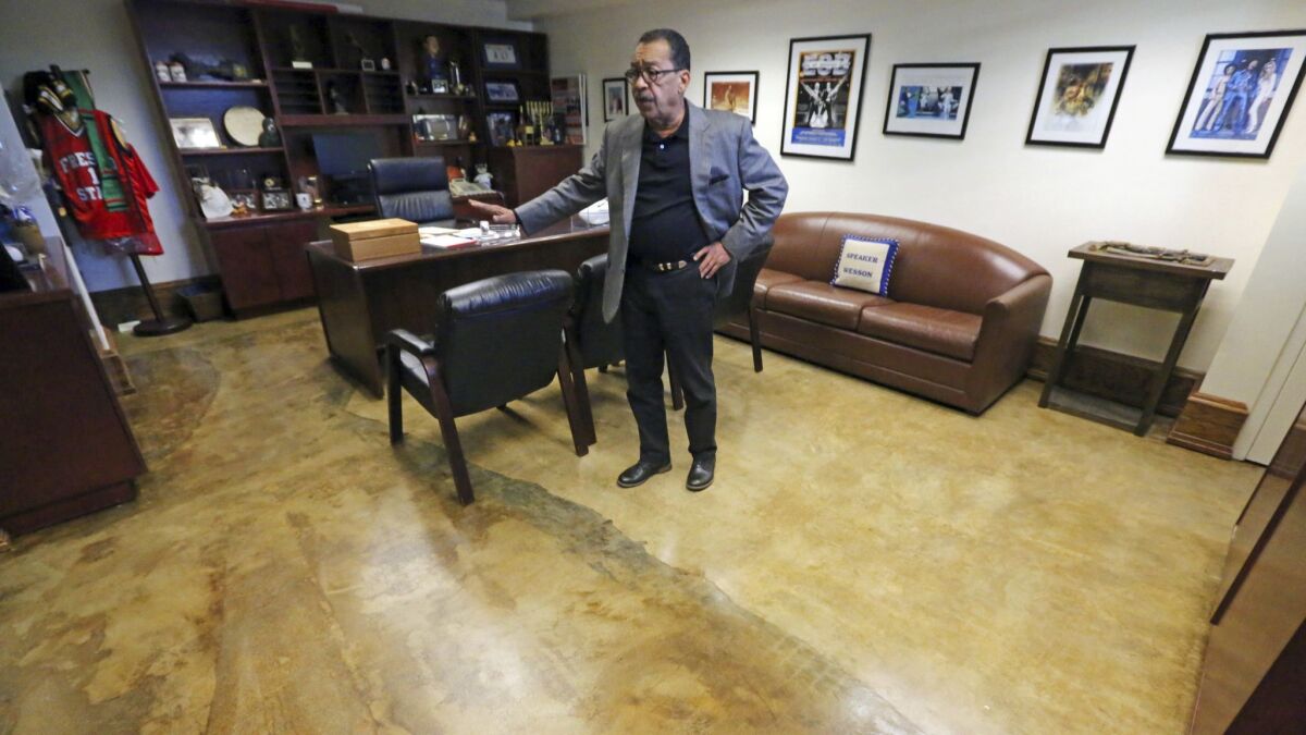 Los Angeles City Council President Herb Wesson shows where carpet has been removed from his office due to vermin infestation at City Hall.