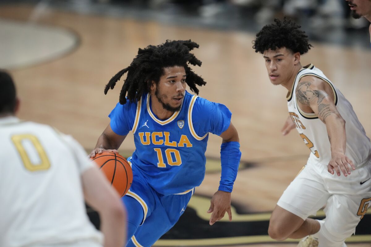 UCLA guard Tiger Campbell and Colorado guard KJ Simpson in the first half.