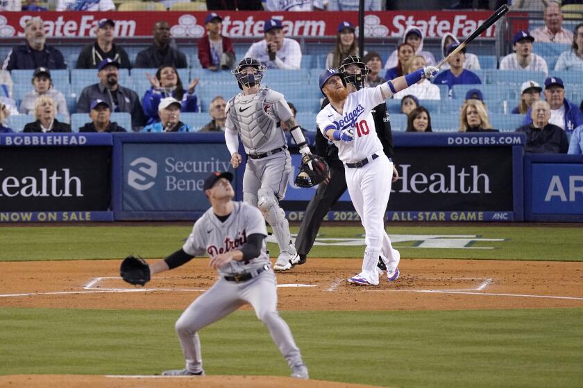 Los Angeles Dodgers' Justin Turner, right, heads to first after hitting a two-run home run.