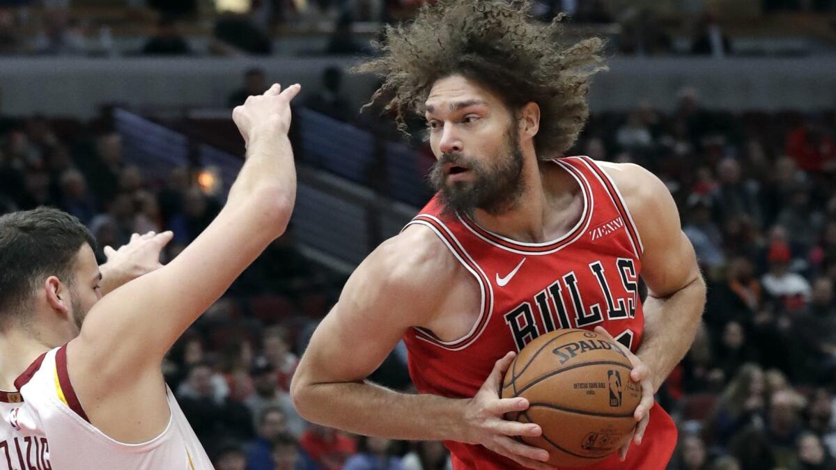 Chicago Bulls center Robin Lopez drives against Cleveland Cavaliers center Ante Zizic during the first half Jan. 27 in Chicago. (AP Photo/Nam Y. Huh)