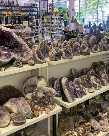 Shelves laden with crystals and geodes in a store.
