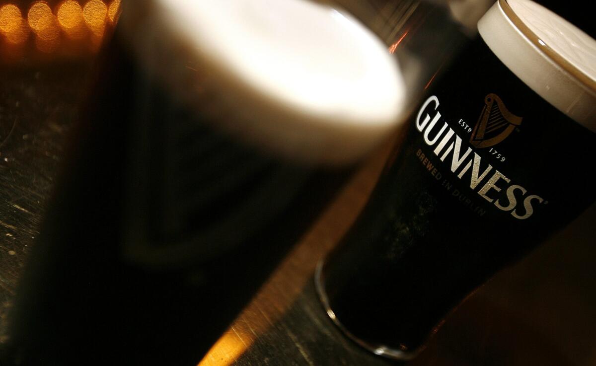 Pints of the signature Irish stout Guinness.