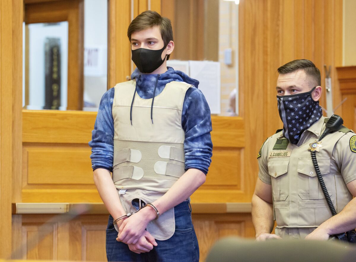 FILE - Willard Noble Chaiden Miller is escorted into a bond review hearing at the Jefferson County Courthouse in Fairfield, Iowa, in this Nov. 23, 2021 file photo. Jeremy Everett Goodale and Willard Noble Chaiden Miller, two southeast Iowa teenagers are charged with first-degree murder and conspiracy to commit murder in the death of their high school Spanish teacher. Christine Branstad, the attorney for Miller filed on Wednesday, Dec. 9, documents asking the judge to transfer his case to juvenile court saying he was 16 at the time of the alleged acts. (Zach Boyden-Holmes/The Des Moines Register via AP, File)