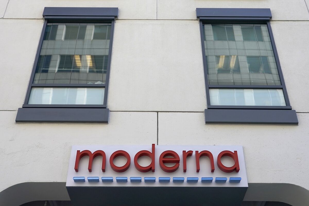 A sign for Moderna, Inc. hangs on its headquarters in Cambridge, Mass.