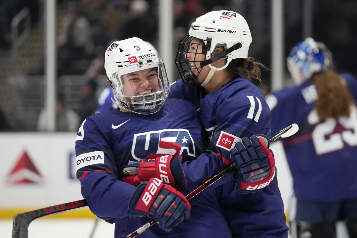 Cayla Barnes, left, celebrates with forward Abby Roque after scoring against Canada in the first period.