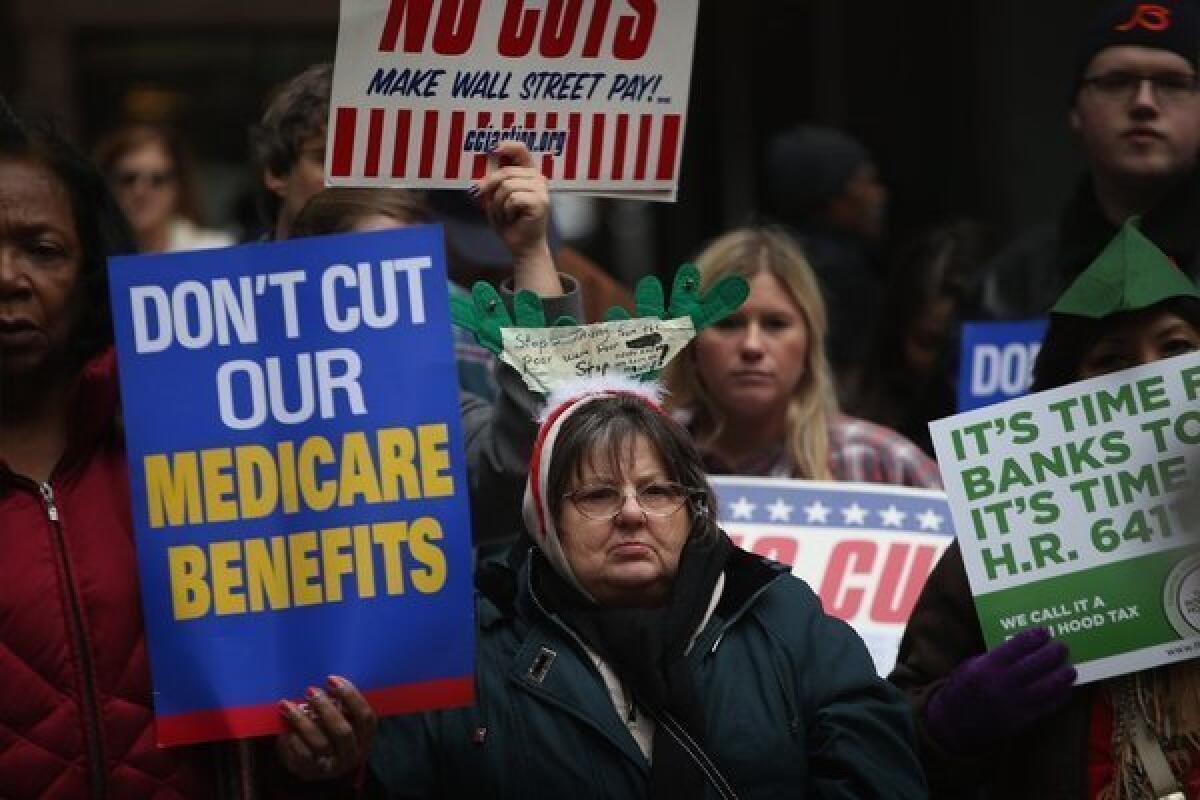 Protestors call for an increase of taxes on the wealthy and voice opposition to cuts in Social Security, Medicare and Medicaid during a demonstration in Chicago on Thursday.