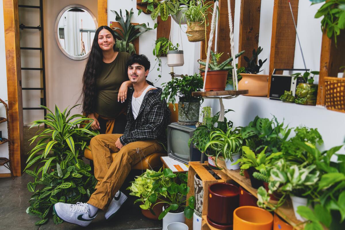 Brittany and Jose Montero stand inside their plant shop 