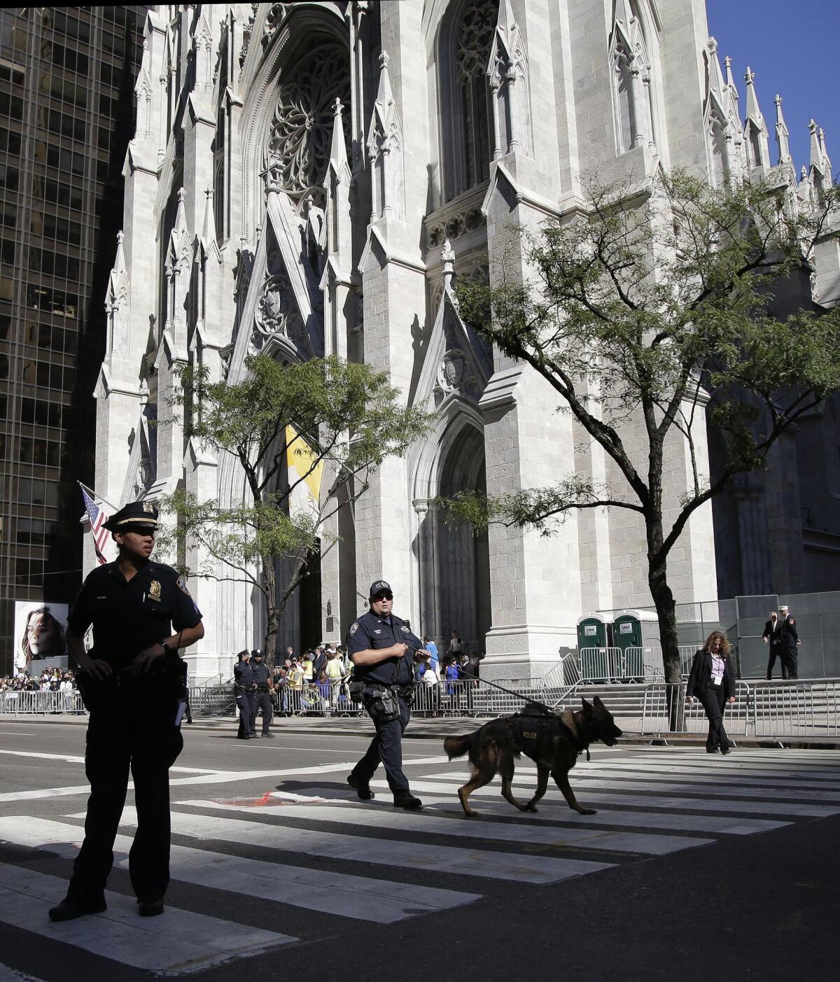 New York Police officers patrol Fifth Avenue in front of St. Patrick's Cathedral in preparation for Pope Francis' arrival to lead an evening prayer service. (AP Photo/Julie Jacobson)
