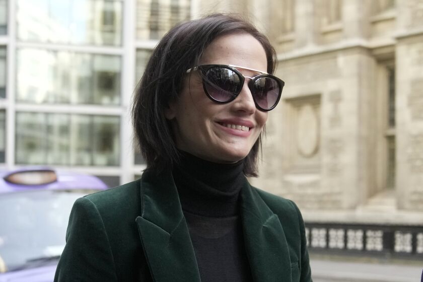 Actress Eva Green arrives at the High Court in London, Monday, Jan. 30, 2023. A lawyer for Eva Green on Thursday, Jan. 26, 2023 accused producers of a collapsed film of trying to damage the performer's reputation by depicting her as a "diva." The French actress, who played Vesper Lynd in James Bond thriller "Casino Royale," is suing producers for a $1 million fee she says she is owed for "A Patriot." (AP Photo/Kin Cheung)