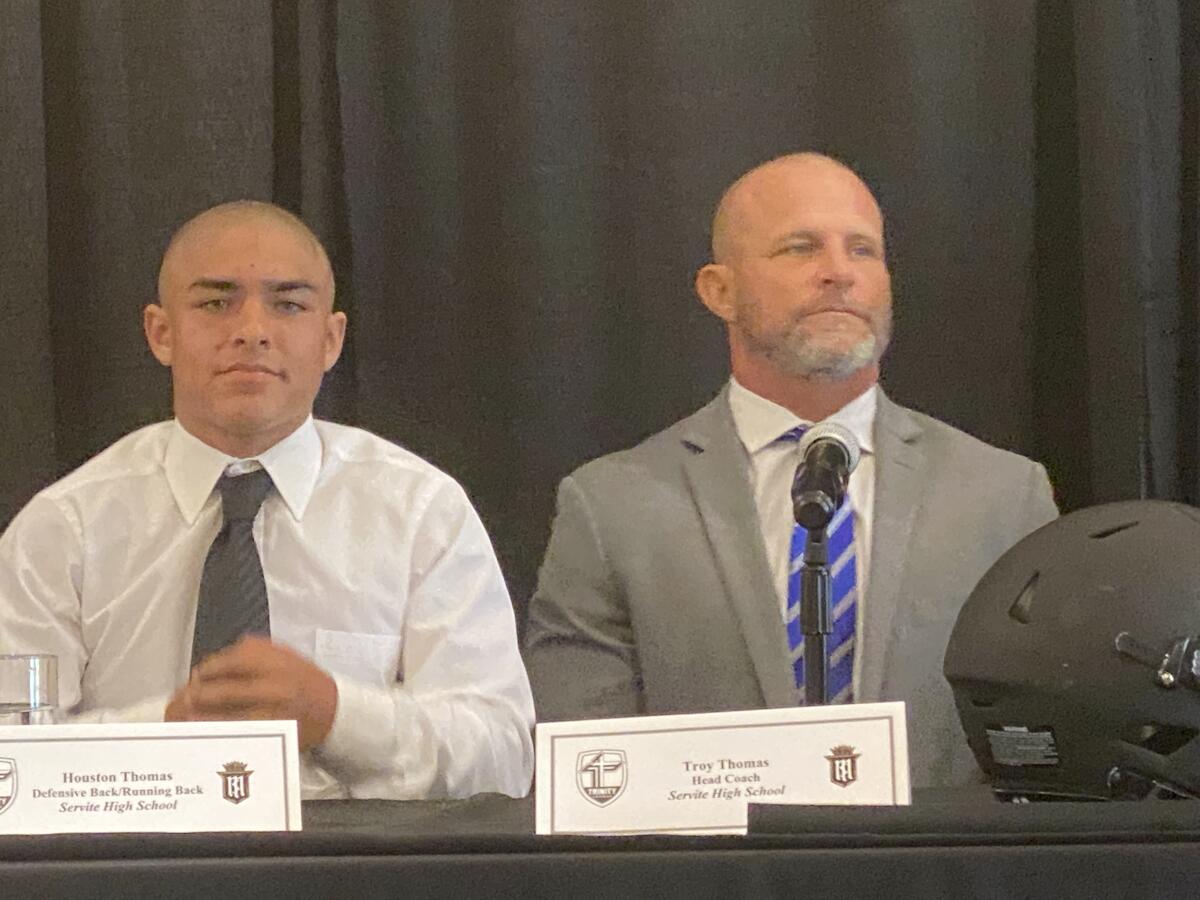 Houston Thomas (left) with his father, Servite coach Troy Thomas, last August during Trinity League media day.