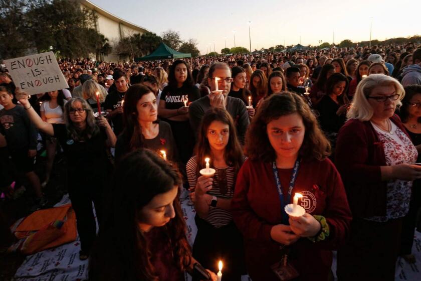 (FILES) In this file photo taken on February 15, 2018 thousands of mourners hold candles during a candlelight vigil for victims of the Marjory Stoneman Douglas High School shooting in Parkland, Florida. - US police have released the name of a second Parkland school shooting survivor who took his life last weekend, days after the suicide of another student.Police in nearby Coral Springs told AFP on March 27, 2019 that Calvin Desir, 16, died Saturday of an apparent suicide. Desir was one of the survivors of a shooting rampage on Valentine's Day last year at Marjory Stoneman Douglas High School when a former student walked in with an AR-15 assault rifle and killed 17 people. (Photo by RHONA WISE / AFP)RHONA WISE/AFP/Getty Images ** OUTS - ELSENT, FPG, CM - OUTS * NM, PH, VA if sourced by CT, LA or MoD **