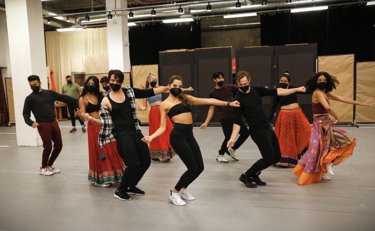 The cast of "Come Fall in Love — The DDLJ Musical" rehearse a dance scene at the Old Globe Theatre.