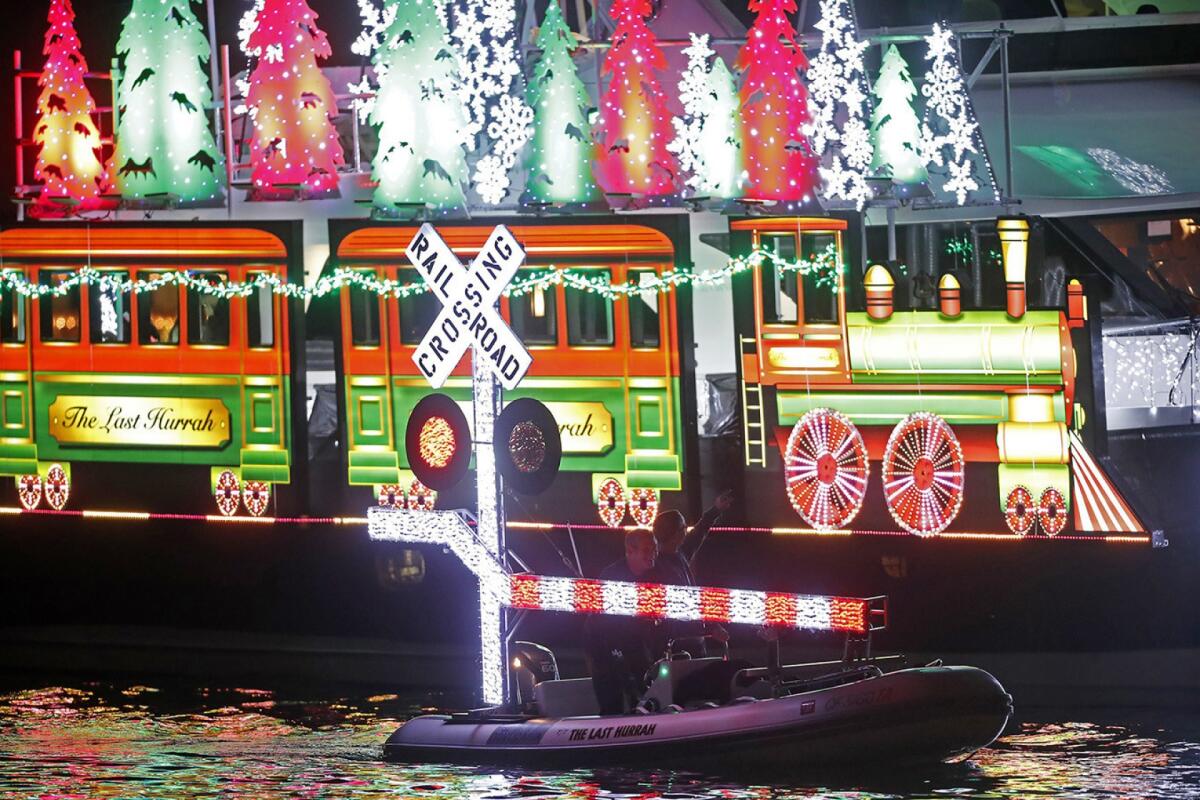 A boat disguised as a train cruises on opening night of the 2017 Newport Beach Christmas Boat Parade.