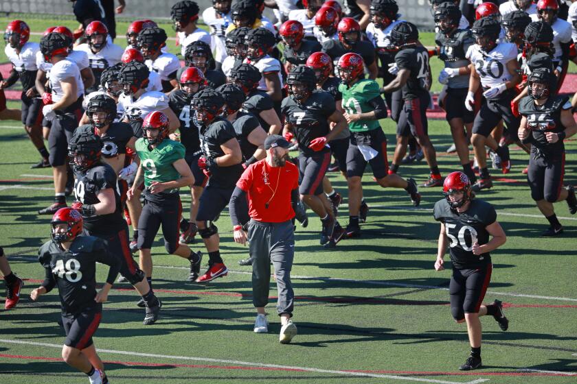 San Diego CA - March 19: San Diego State football coach Sean Lewis breaks for a spring practice on Tuesday, March 19, 2024 in San Diego, CA. (K.C. Alfred / The San Diego Union-Tribune)
