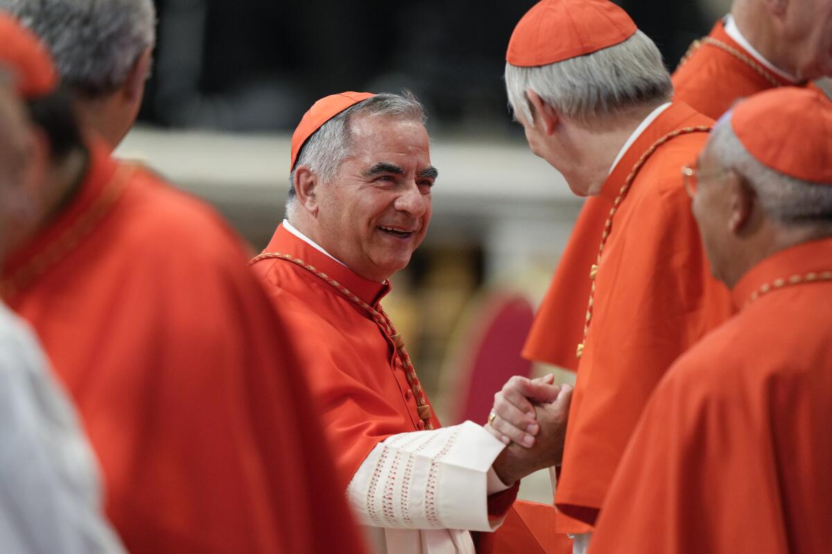 Cardinal Angelo Becciu stands among other cardinals.