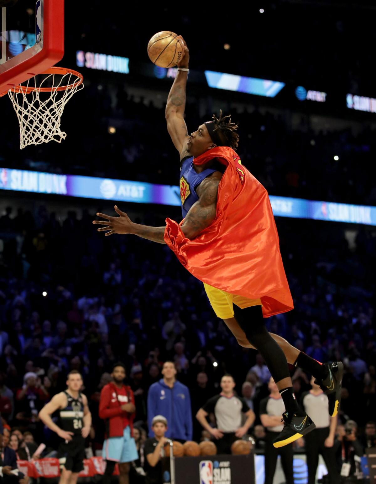 Dwight Howard soars to the rim for a dunk in his modified Superman outfit.