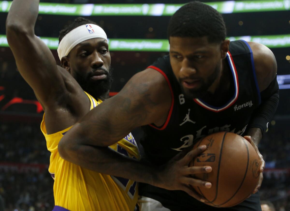 Lakers guard Patrick Beverley defends against Clippers forward Paul George.