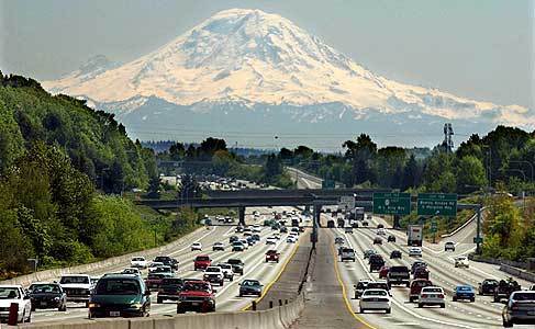 On a clear Sunday morning, motorists on Interstate 5 near Seattle get a spectacular view of Mt. Rainier. During peak hours, commuter traffic crawls along the central city part of the freeway.