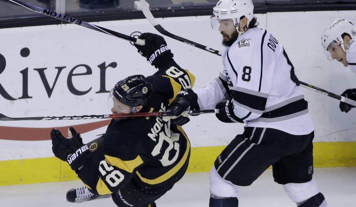 The Kings' Drew Doughty, right, gets into a tussle with Boston's Dominic Moore during Sunday's game.