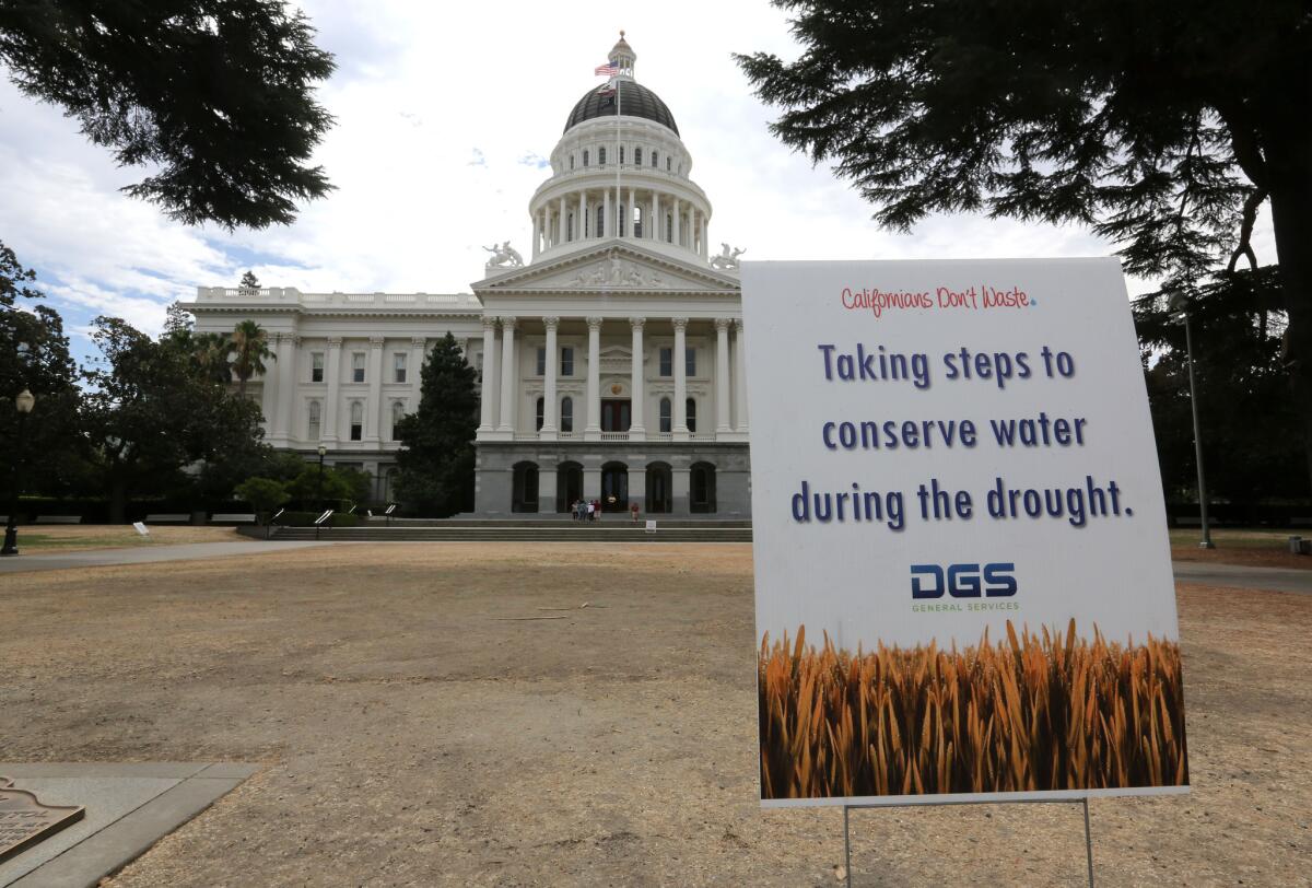 A sign alerts visitors to water conservation efforts at the state Capitol, where lawn watering has been reduced because of the drought. The Legislature on Wednesday reached a deal on $7.5 billion water bond to increase and preserve the state's water supply.