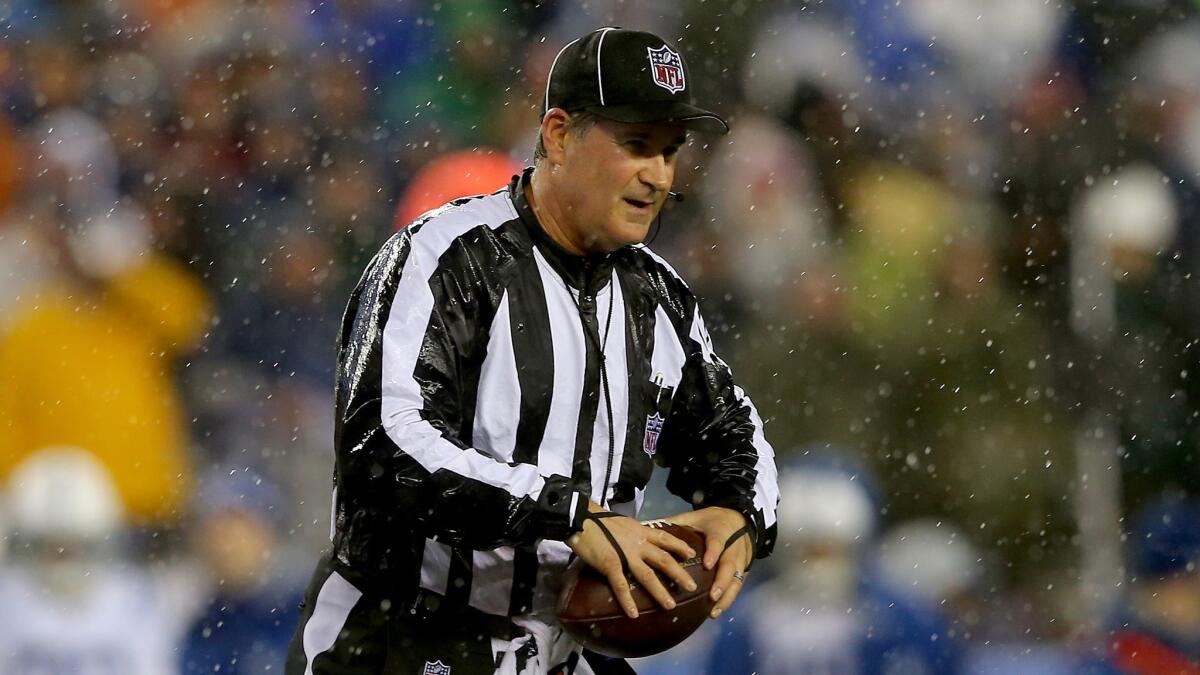 Official Carl Paganelli holds a ball during the AFC Championship game between the New England Patriots and Indianapolis Colts on Jan. 18.