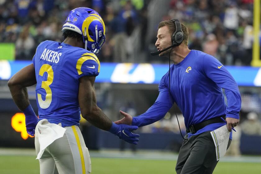 Los Angeles Rams running back Cam Akers (3) is congratulated by head coach Sean McVay.