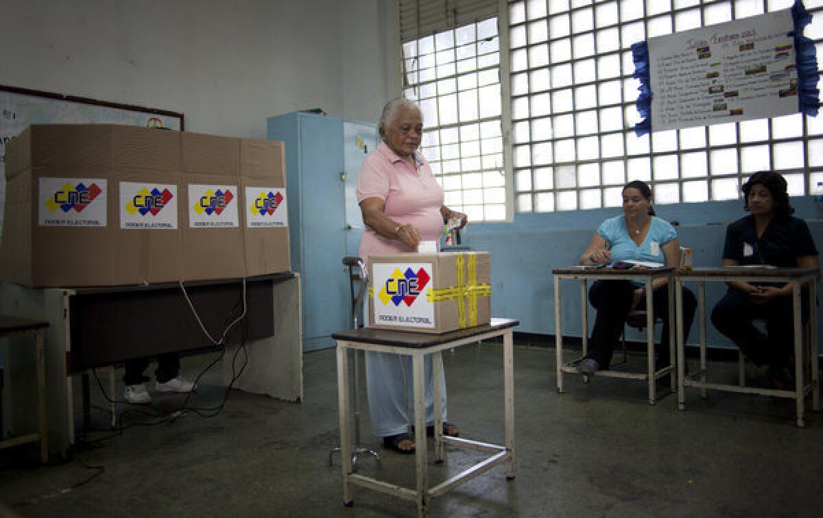 A woman casts her ballot in the presidential election in Caracas, Venezuela.