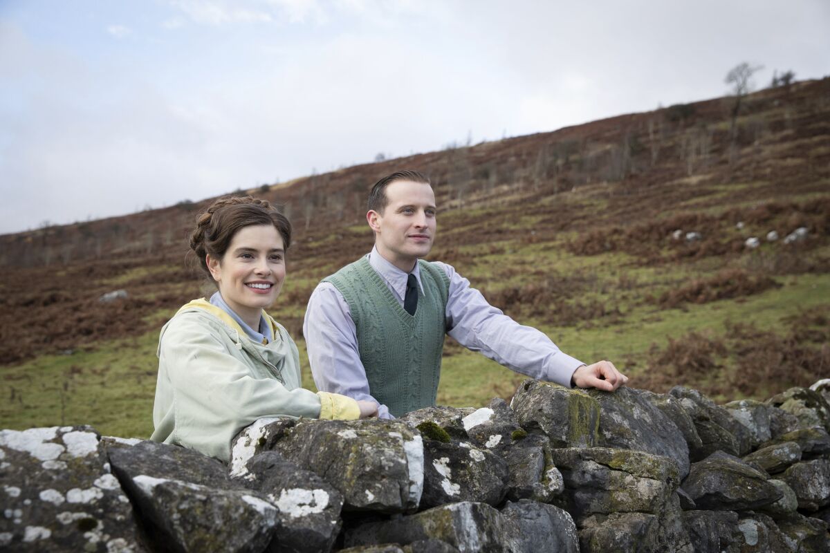 This image released by PBS shows Rachel Shenton and Nicholas Ralph, right, in a scene from "All Creatures Great and Small on MASTERPIECE." The seven-part series based on James Herriot’s adventures as a veterinarian in 1930’s Yorkshire premieres on Sunday. (Ed Miller/Playground Television and PBS via AP)