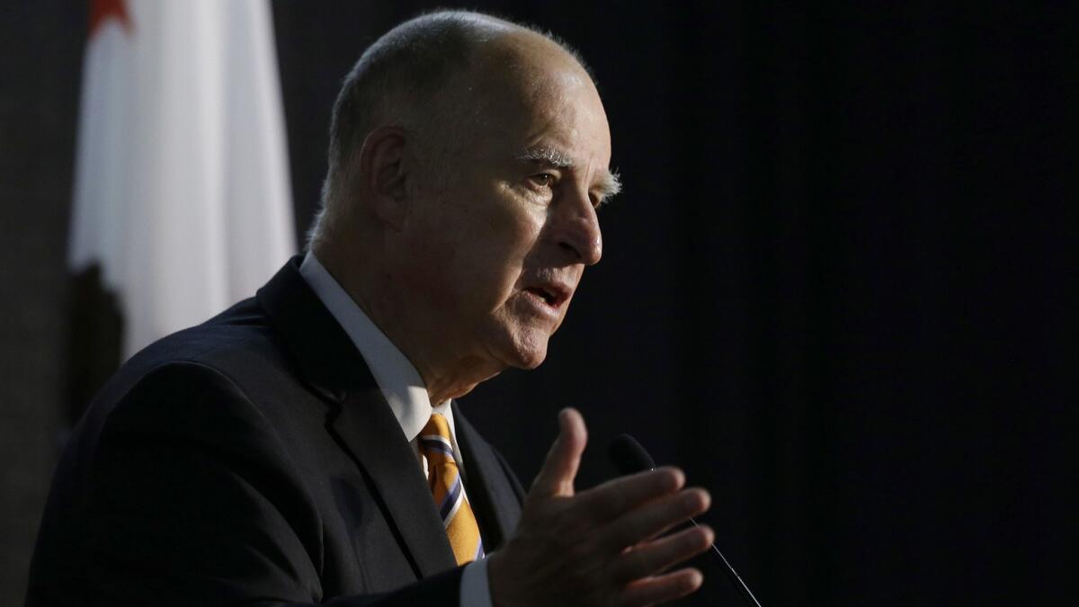 Gov. Jerry Brown, shown in June, signed the nation's toughest net neutrality measure on Sunday, prompting a lawsuit from the federal government.
