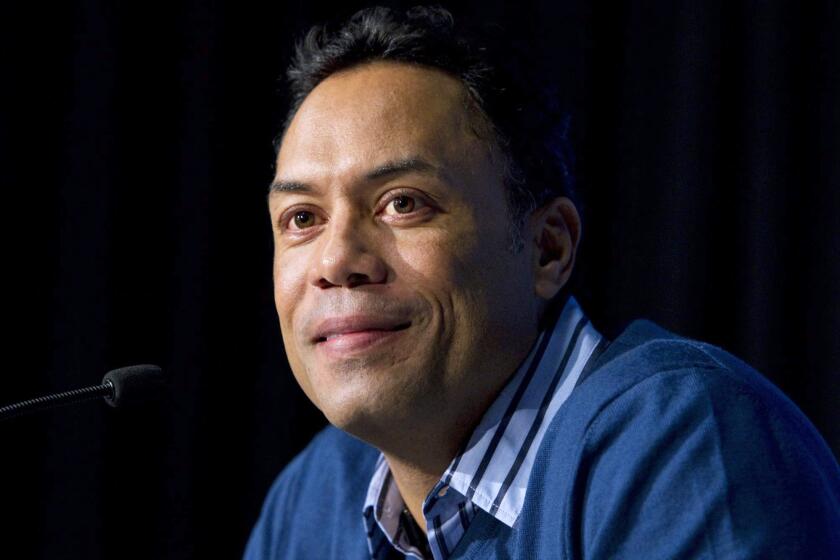 FILE - In this Jan. 5, 2011, file photo, former Toronto Blue Jays player Roberto Alomar smiles during a news conference in Toronto. The Hall of Fame second baseman has been fired as a consultant by Major League Baseball and placed on the league's ineligible list following an investigation into an allegation of sexual misconduct, Commissioner Rob Manfred announced Friday, April 30, 2021. (Darren Calabrese/The Canadian Press via AP, File)