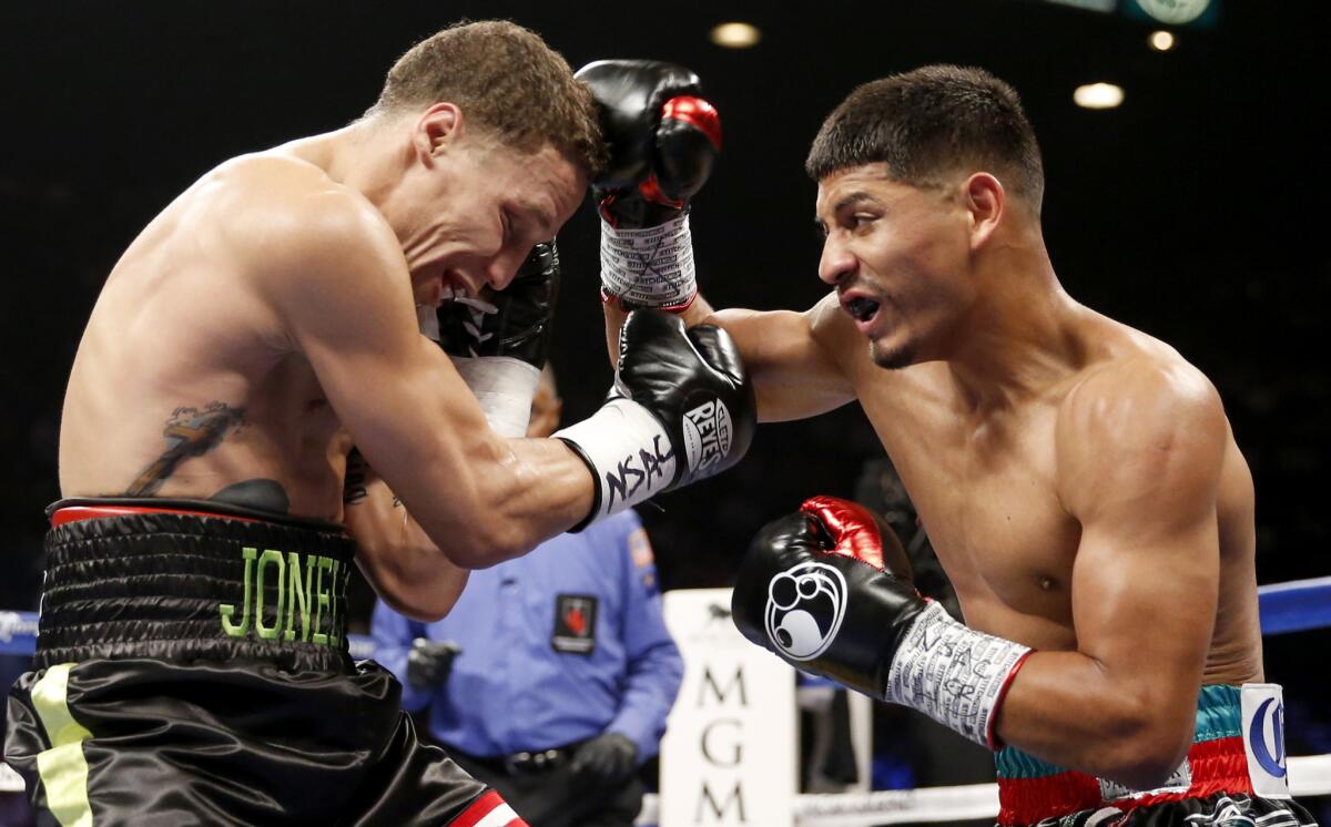 Abner Mares hits Jonathan Oquendo, left, during a featherweight bout July 12 in Las Vegas.