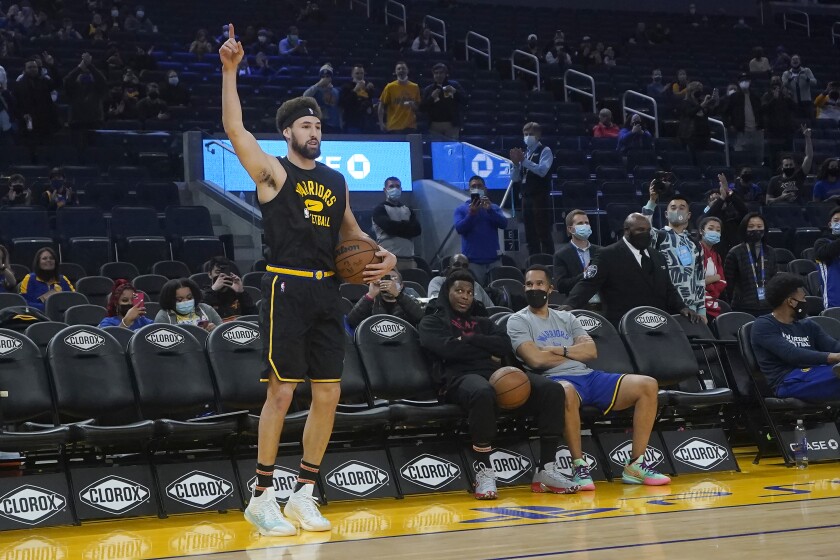 Golden State Warriors guard Klay Thompson gestures while warming up before an NBA basketball game between the Warriors and the Miami Heat in San Francisco, Monday, Jan. 3, 2022. (AP Photo/Jeff Chiu)