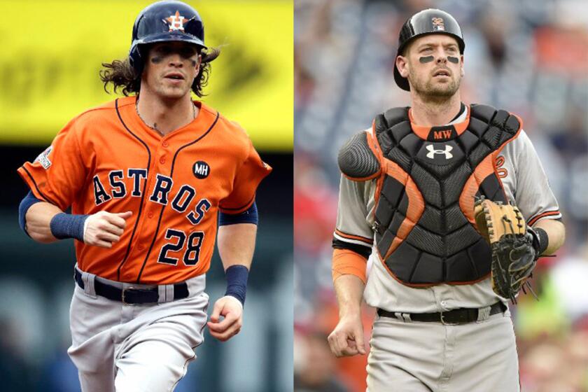 Houston's Colby Rasmus, left, and Baltimore's Matt Wieters are the first players ever to accept qualifying offers to remain with their teams.