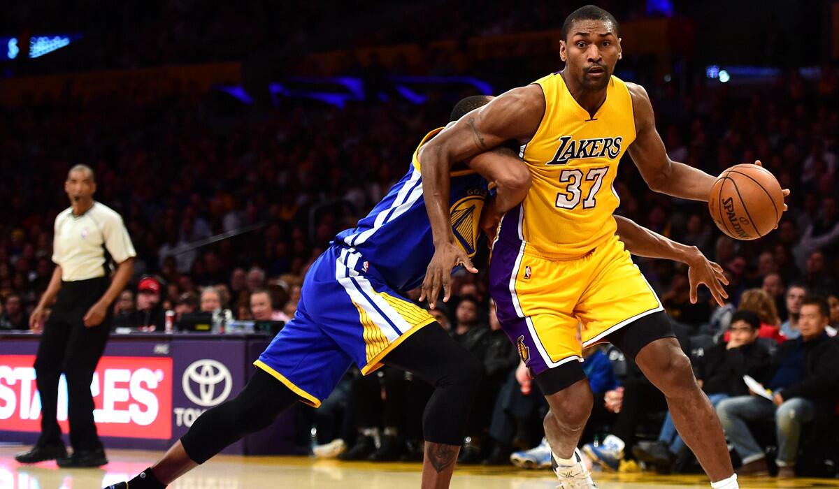 Lakers' Metta World Peace drives on Warriors' Andre Iguodala during a 109-88 loss at Staples Center on Tuesday.