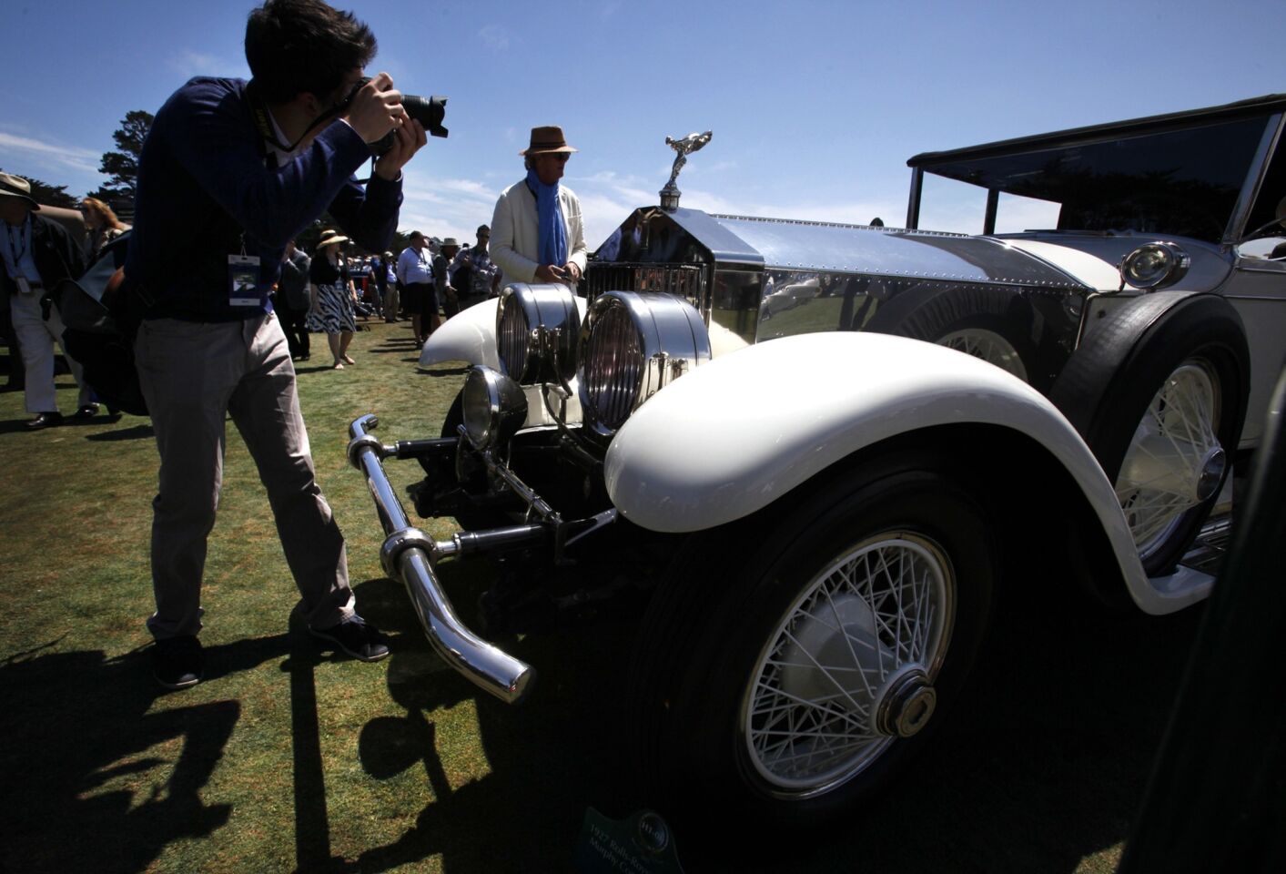 Ben Rehm, 20, of Carmel photographs a 1927 Rolls-Royce Phantom I Murphy Convertible Saloon at the Concours d'Elegance on Sunday.