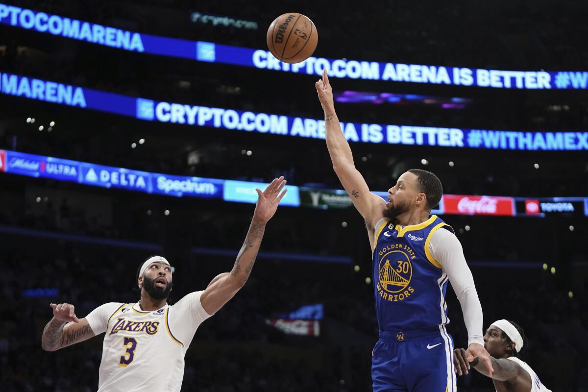 Warriors guard Stephen Curry releases a shot over Lakers forward Anthony Davis during Game 3.