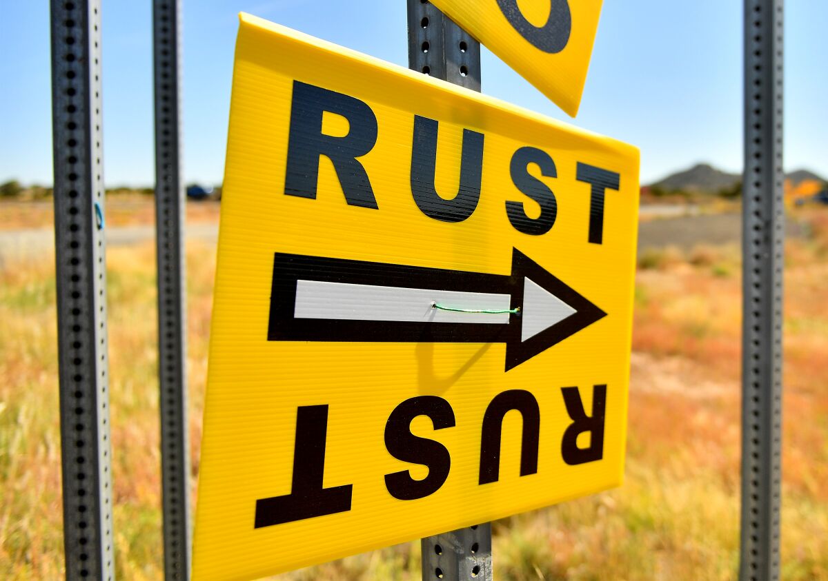 A bright yellow sign points toward the "Rust" filming location