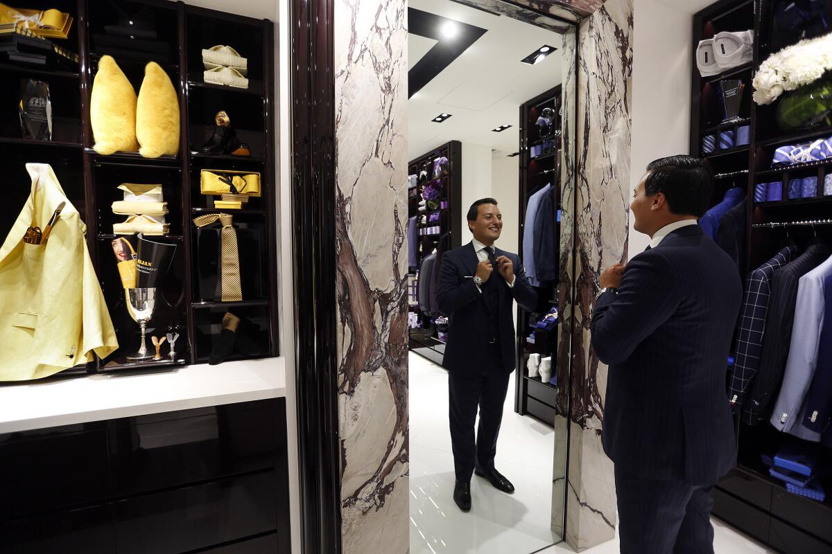 Nicolas Bijan Pakzad fixes his tie at the Bijan boutique inside the Waldorf Astoria hotel in Beverly Hills. The brand also has a flagship store on Rodeo Drive.