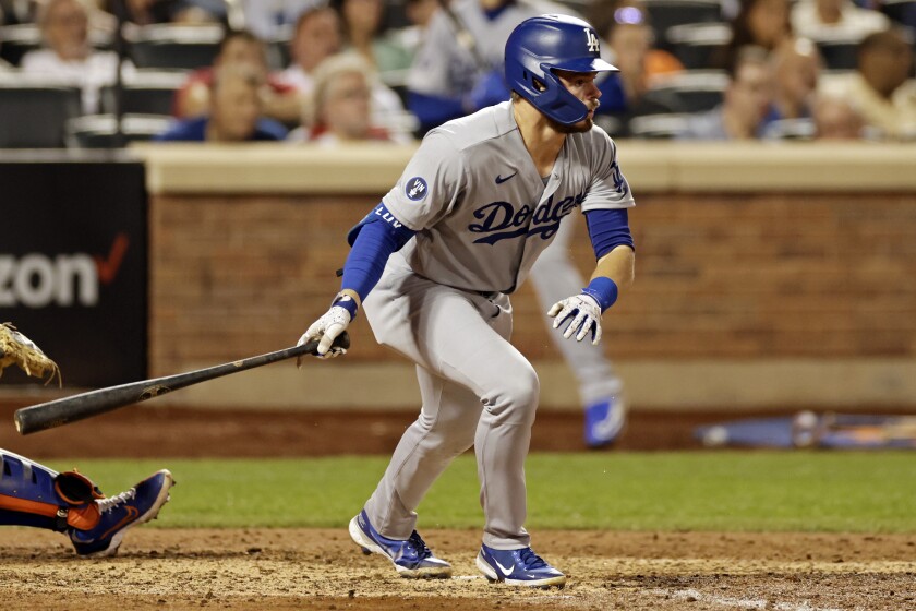 Dodgers' Gavin Lux watches his RBI single against the New York Mets.