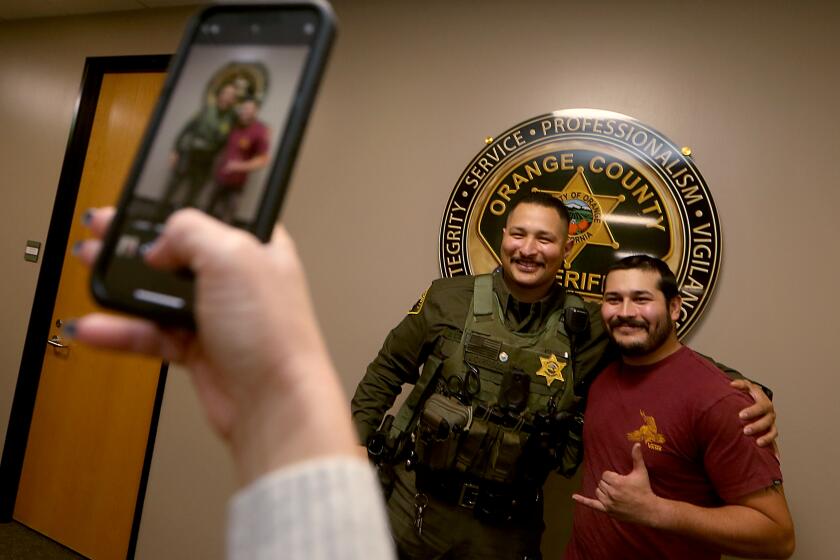 Lake Forest, CA - Orange County Sheriff's Deputy Jesse Carrasco, who responded to the Cook's Corner shooting in August, formally met for the first time with off-duty security guard Nelson Rosales who was inside the bar at the time of the shooting. Rosales ran out of the bar to warn deputies about the shooter's location, preventing them from walking into the gunman. (Luis Sinco / Los Angeles Times)