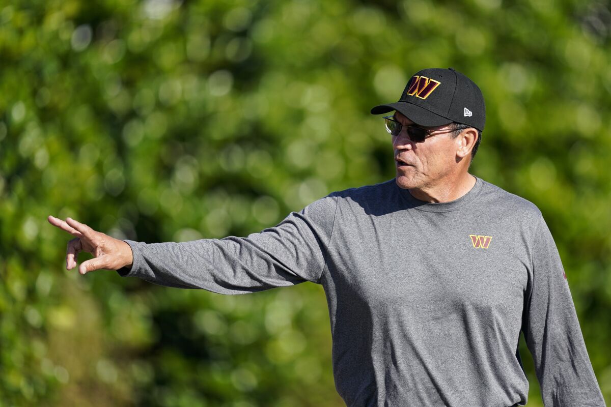 Washington Commanders head coach Ron Rivera waves to fans as he arrives for practice at the NFL football team's training facility, Tuesday, Aug. 9, 2022, in Ashburn, Va. (AP Photo/Alex Brandon)