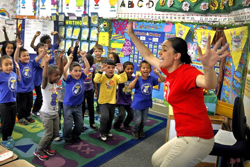 Teacher Adriana Rosas leads kindergarten students reciting nutrition chants at Aloha Health Medical Academy in Lakewood. The campus is part of the ABC Unified School District, which also serves Hawaiian Gardens.