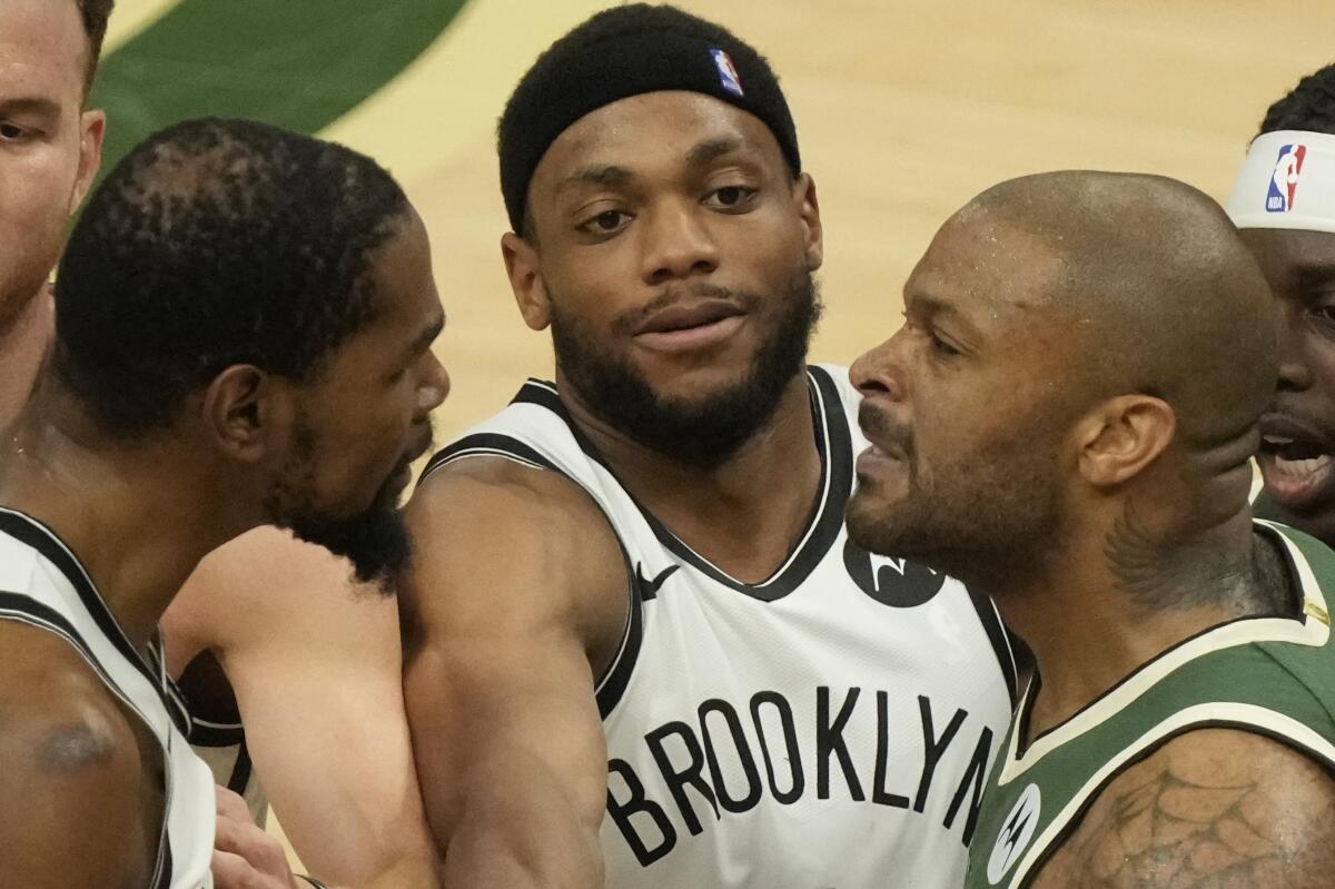 Brooklyn Nets' Bruce Brown tries to break up Kevin Durant and Milwaukee Bucks' P.J. Tucker during the second half of Game 3 of the NBA Eastern Conference basketball semifinals game Thursday, June 10, 2021, in Milwaukee. (AP Photo/Morry Gash)