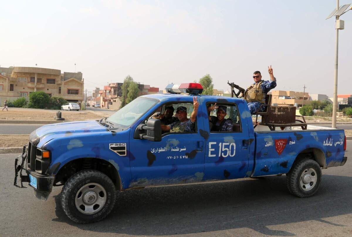Iraqi police patrol Kirkuk after driving off a counterattack by Islamic State fighters.