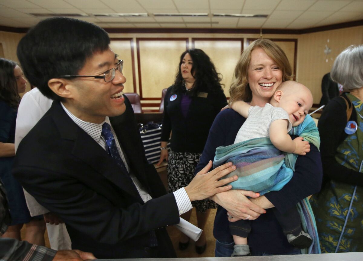 State Sen. Richard Pan (D-Sacramento), left, talks with Jennifer Wonnacott, a supporter of Pan's measure requiring California schoolchildren to get vaccinated, after the bill was approved by the Senate on May 14.