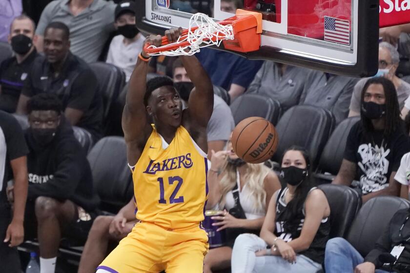 Los Angeles Lakers center Devontae Cacok dunks against the Sacramento Kings during the first half of an NBA summer league basketball game in Sacramento, Calif., Wednesday, Aug. 4, 2021. (AP Photo/Rich Pedroncelli)