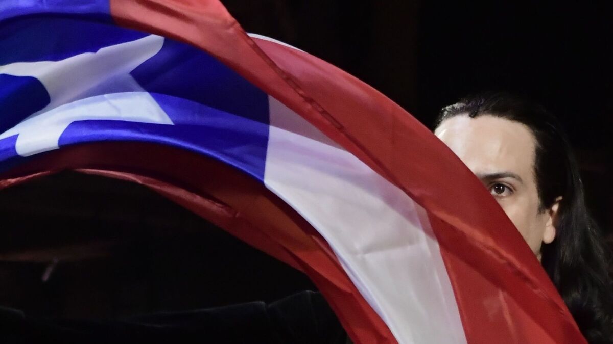 Lin-Manuel Miranda waves the Puerto Rican flag at the premiere of "Hamilton" in San Juan.