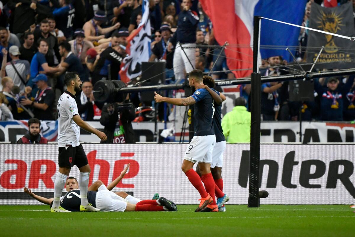 France's forward Kingsley Coman (number 11) celebrates after scoring a goal with France's forward Olivier Giroud (09) as France's defender Lucas Hernandez lies on the ground during the UEFA Euro 2020 qualifying Group H football match between France and Albania at the Stade de France stadium in Paris on September 7, 2019. (Photo by Lionel BONAVENTURE / AFP)LIONEL BONAVENTURE/AFP/Getty Images ** OUTS - ELSENT, FPG, CM - OUTS * NM, PH, VA if sourced by CT, LA or MoD **