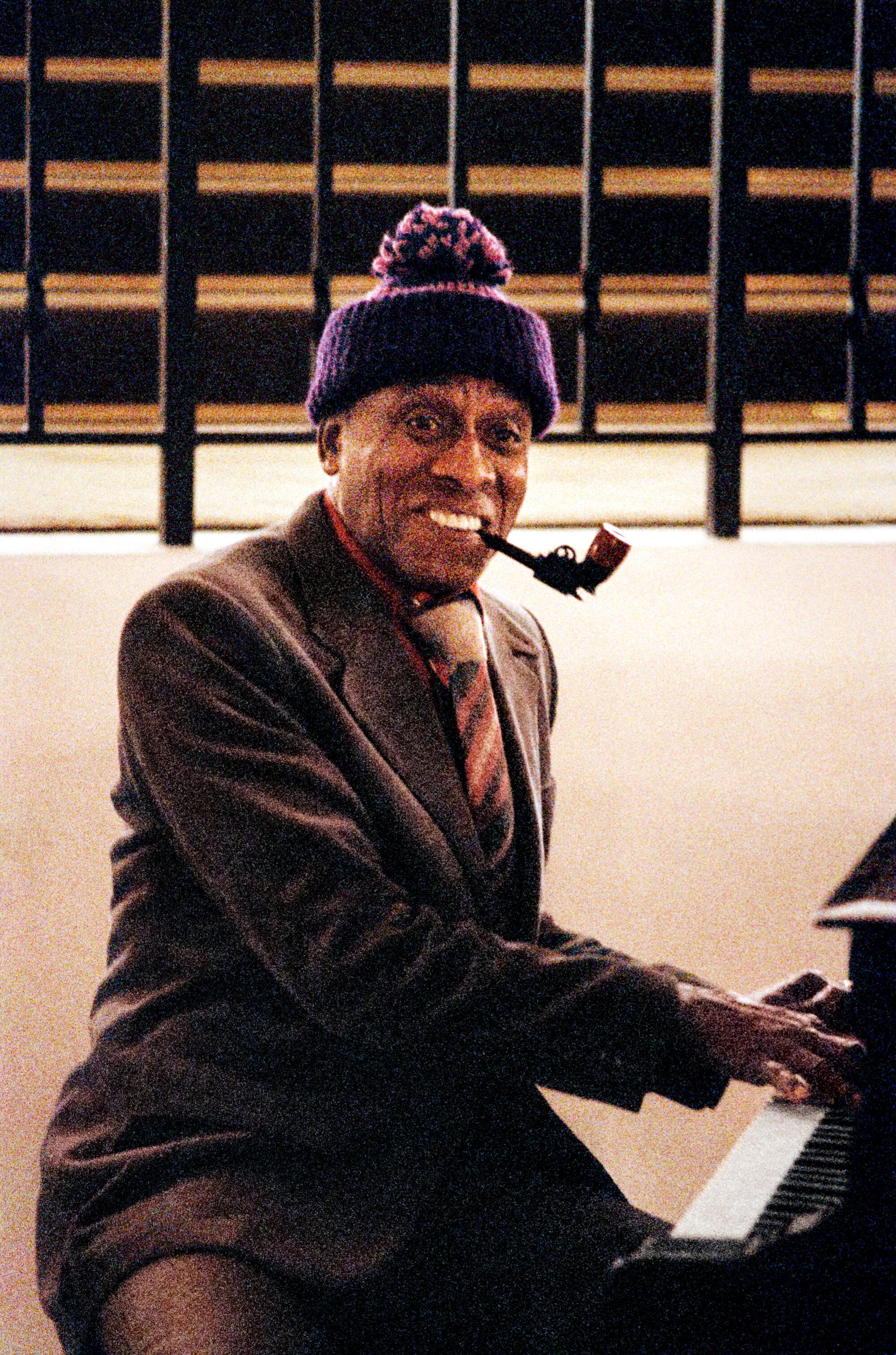 A man at a piano smiles